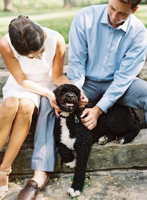 a man and woman petting a dog